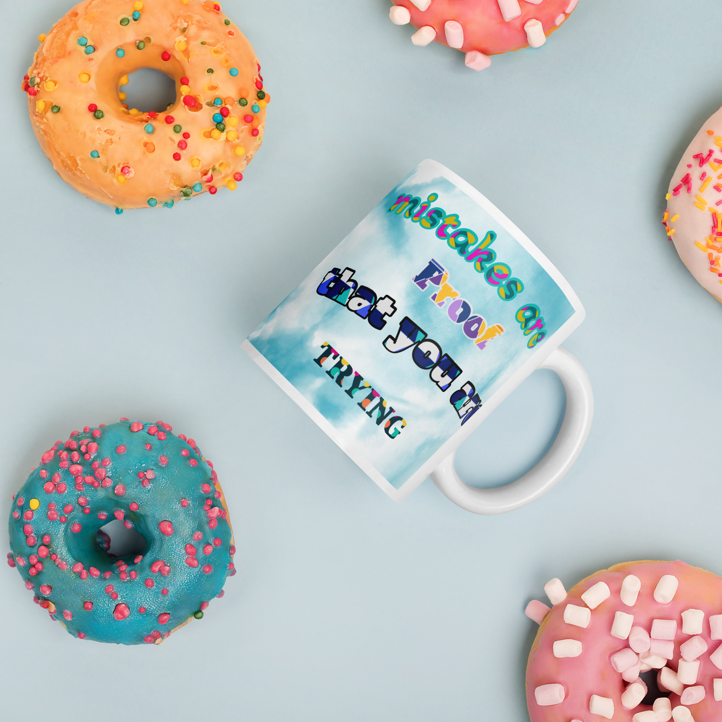 Ceramic mug with motivational quote surrounded by colorful donuts, great unique gift for any occasion.