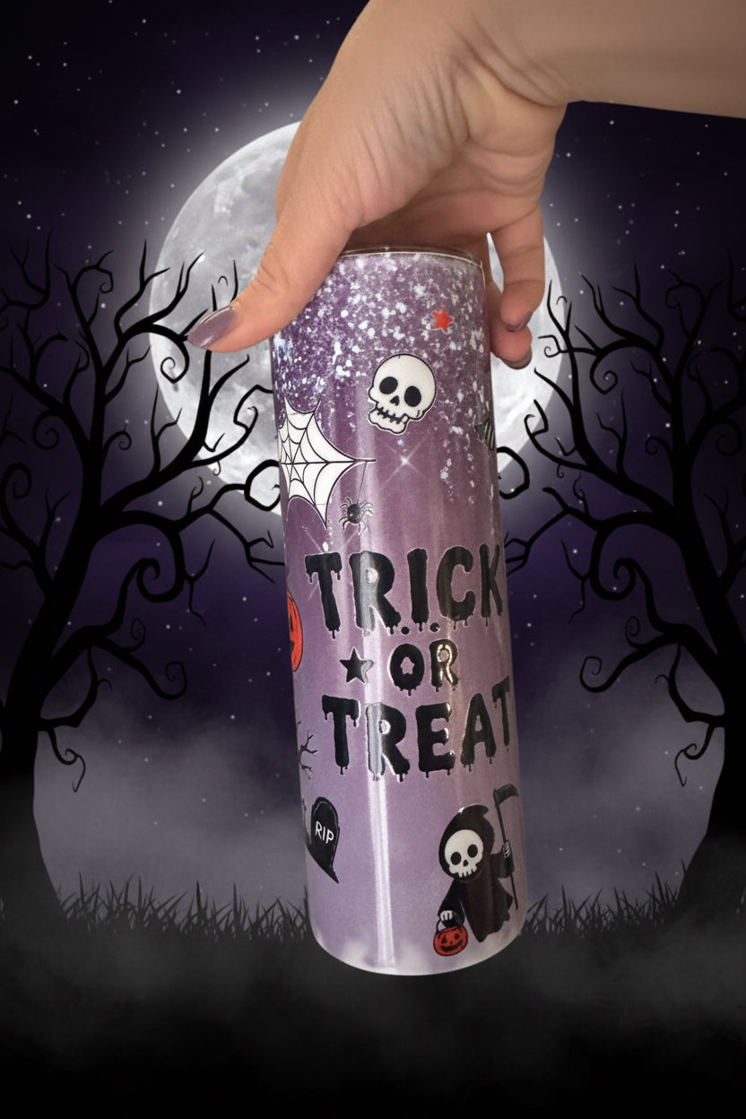 Purple glitter Halloween tumbler with Trick or Treat text, skulls and grim reaper design