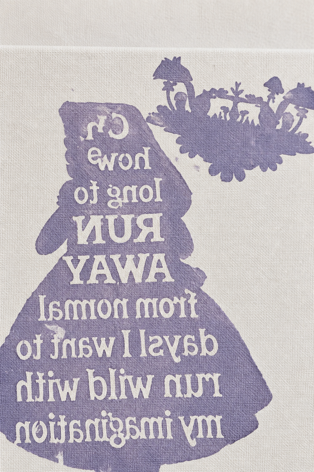 Close-up detail of the lavender silhouette girl artwork with backwards lettering