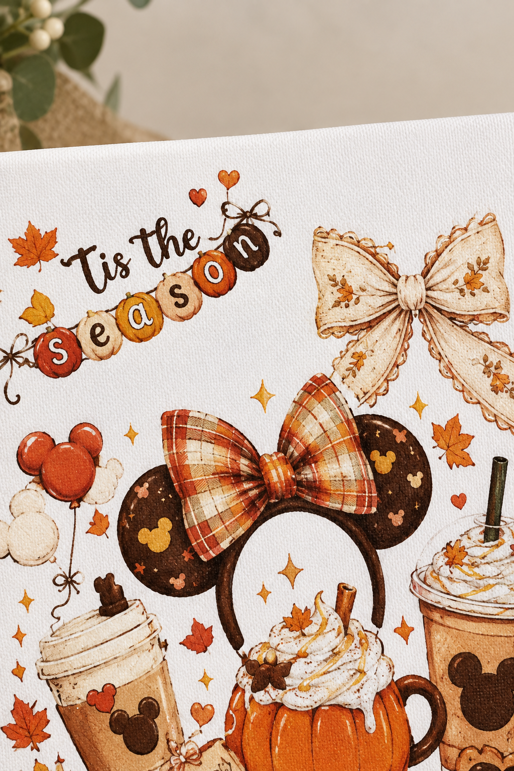 Close-up detail of the Tis the Season banner and bows on the canvas sign