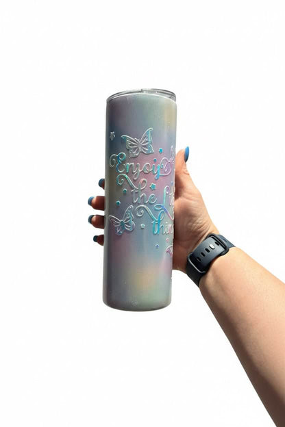 Handmade holographic stainless steel tumbler with butterfly design and quote 'Enjoy the Little Things' in hand.