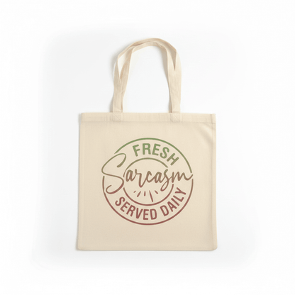 Funny canvas tote bag featuring a bold graphic reading 'Fresh Sarcasm Served Daily' in green and red.