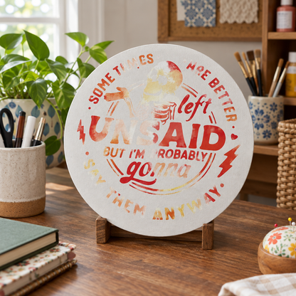 Handmade funny round sign displayed in a cozy craft room