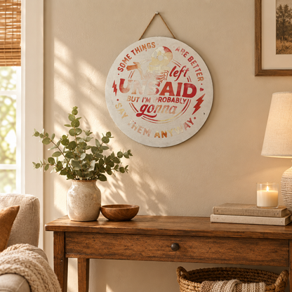 Handmade funny round sign displayed on a living room wall