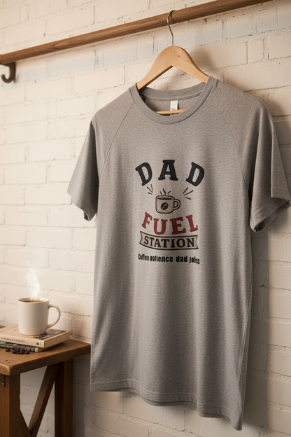 Dad Fuel Station T-Shirt hanging on a rack, featuring coffee-themed graphic and slogan, perfect for coffee-loving dads.
