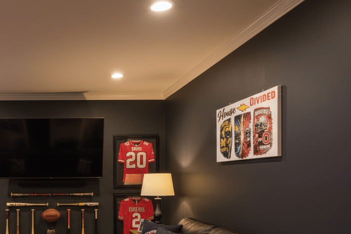 House Divided Michigan vs Ohio State rivalry sign displayed in a stylish man cave with sports memorabilia.