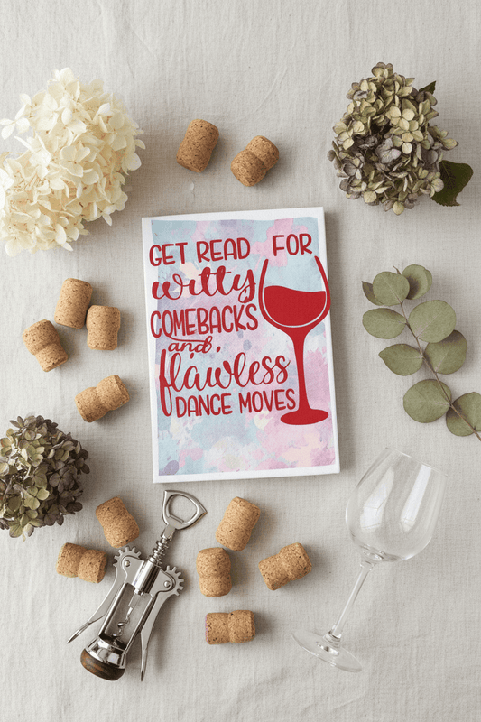 handmade witty comebacks canvas sign surrounded by corks, a corkscrew, and a glass on a table.