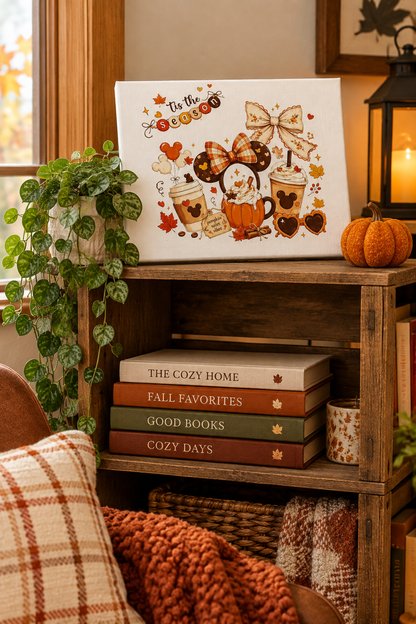 Tis the Season canvas sign on a wooden crate shelf with books and a trailing plant