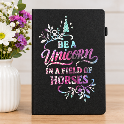 Unicorn journal beside flowers