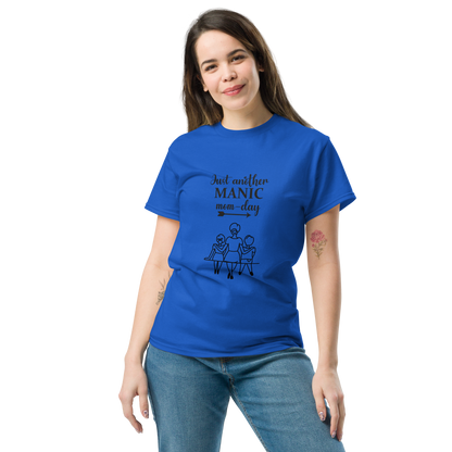 Woman wearing a blue cotton tee with 'Just another MANIC mom-day' graphic, ideal for trendy streetwear.